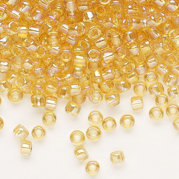 Seed bead, Dyna-Mites™, glass, transparent rainbow amber yellow, #6 round. Sold per 40-gram pkg. image number 0