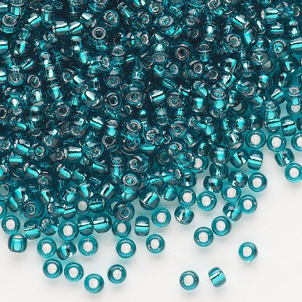 Seed bead, Dyna-Mites™, glass, silver-lined translucent teal blue, #8 round. Sold per 40-gram pkg. image number 0