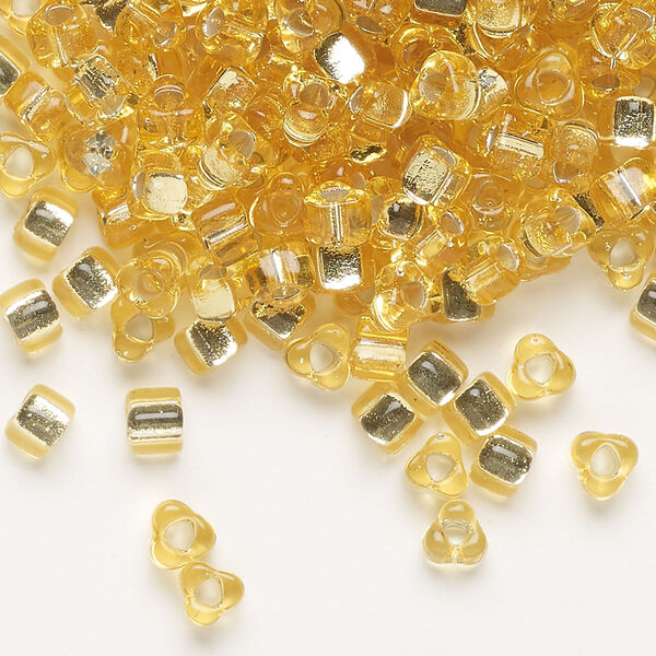 Seed bead, Miyuki, glass, silver-lined translucent amber yellow, (TR1102), #5 triangle. Sold per 250-gram pkg. image number 0