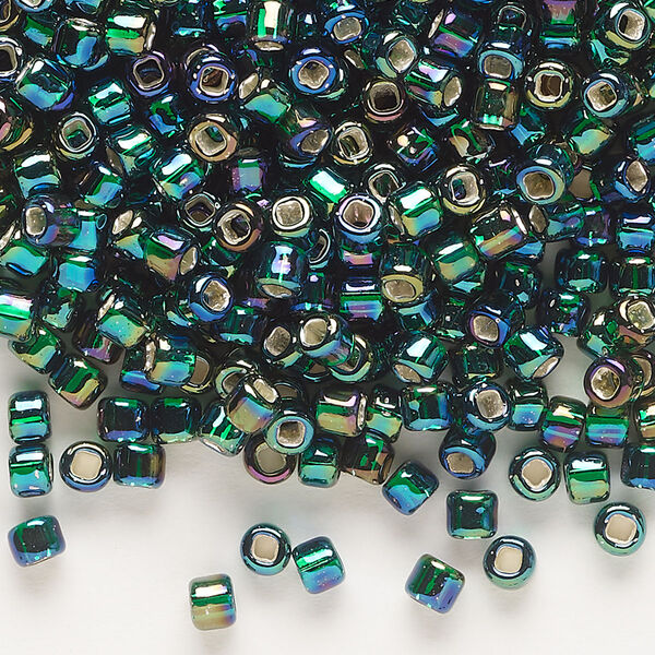 Seed bead, Dyna-Mites™, glass, silver-lined translucent rainbow dark green, #6 round with square hole. Sold per 40-gram pkg. image number 0
