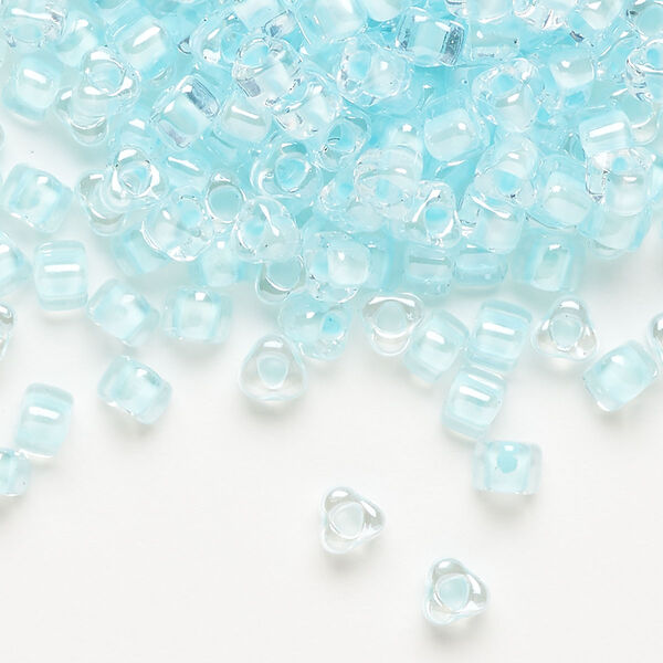 Seed bead, Miyuki, glass, transparent clear color-lined ice blue, (TR1112), #5 triangle. Sold per 250-gram pkg. image number 0