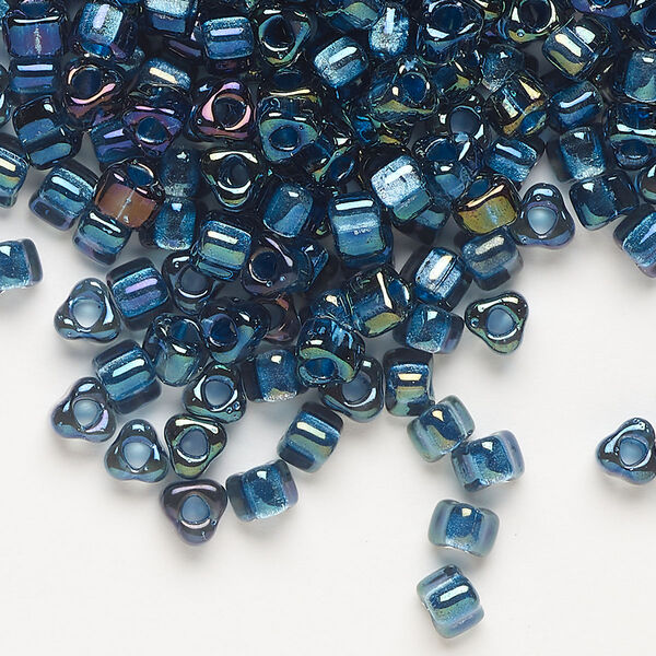 Seed bead, Miyuki, glass, transparent blue color-lined metallic blue, (TR1831), #5 triangle. Sold per 25-gram pkg. image number 0