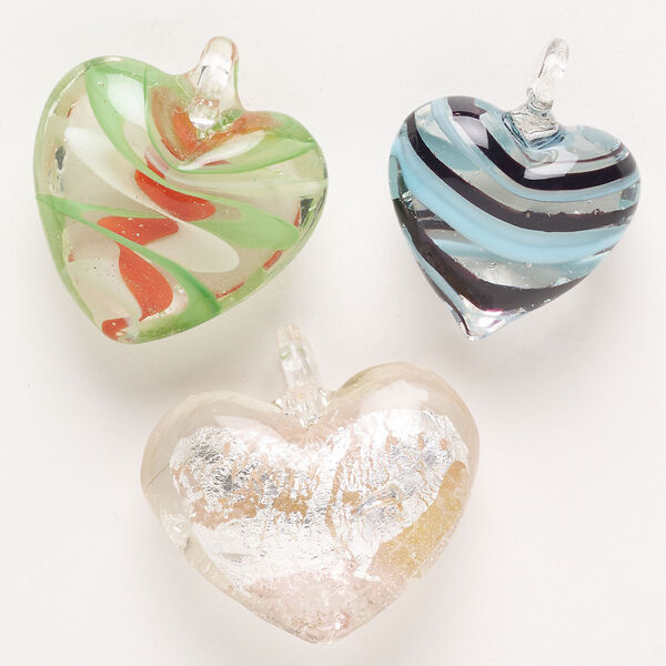 Random focal mix, lampworked glass, pkg/3, opaque to transparent mixed colors with silver-colored foil and copper-colored glitter, 30x26mm-40x34mm puffed heart. image number 0