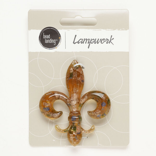 Focal, lampworked glass, opaque and translucent tan/ blue / green, 60x49mm fleur-de-lis with copper-colored glitter. Sold individually. image number 0