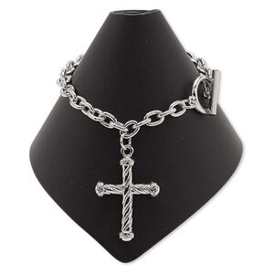 Bracelet, imitation rhodium-plated steel and "pewter" (zinc-based alloy), 32.5x25mm cross, 7 inches with toggle clasp. Sold individually.