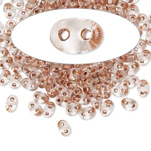 Seed bead, Preciosa Twin™ Czech glass, pkg/50g, 5x2.5mm oval, transparent copper color-lined clear, (68105).